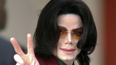 En esta foto del 17 de marzo del 2005, Michael Jackson saluda a sus fans al llegar a la corte del condado de Santa Barbara en Santa María, California. Tribunal envía a arbitraje demanda por Leaving Neverland.