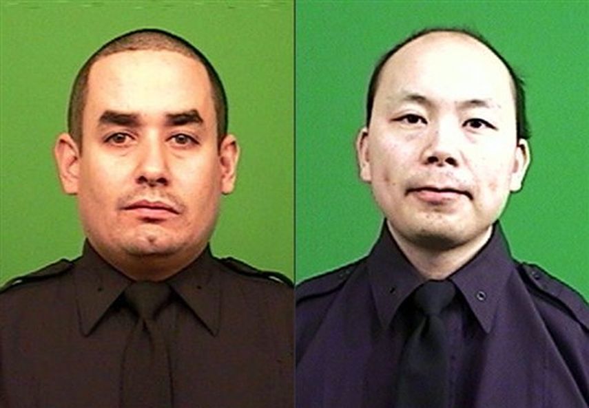 Los policías Rafael Ramos, izquierda, y Wenjian Liu, fueron asesinados dentro de su coche patrulla en Nueva York, el sábado 20 de diciembre de 2014. (AP) 