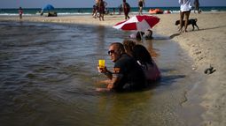 Un grupo de cubanos&nbsp;se refrescan en las aguas poco profundas de las playas del litoral norte, al este de La Habana, Cuba, el jueves 18 de julio de 2019.