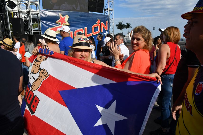 Una boricua porta una bandera gigante de su país durante las Fiestas de la Calle Miami.