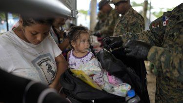 La policía panameña inspecciona el equipaje de Francismar Acosta, de Venezuela, en Lajas Blancas, Panamá, luego de que cruzó el Tapón del Darién desde Colombia con su hija Adhara Figueroa, el jueves 26 de septiembre de 2024.&nbsp;