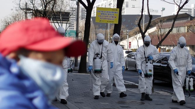 Soldados surcoreanos, con trajes de protecci&oacute;n, esparcen desinfectante sobre una vereda dentro de los esfuerzos para luchar contra la propagaci&oacute;n de un nuevo coronavirus, en Se&uacute;l, Corea del Sur, el 6 de marzo de 2020.&nbsp;