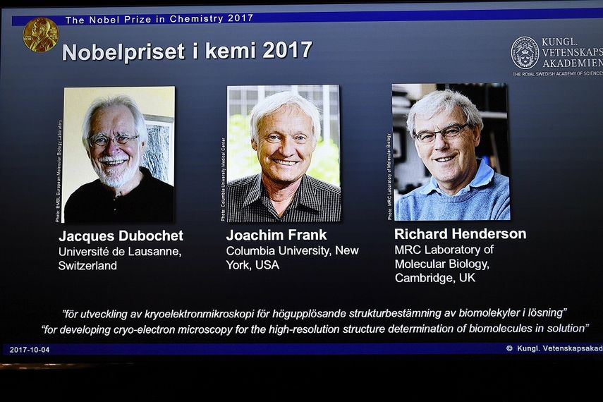 Una pantalla muestra a los tres ganadores del Premio&nbsp;Nobel&nbsp;de Química 2017 por desarrollar la criomicroscopía electrónica para la determinación estructural en alta resolución de biomoléculas en soluciones: