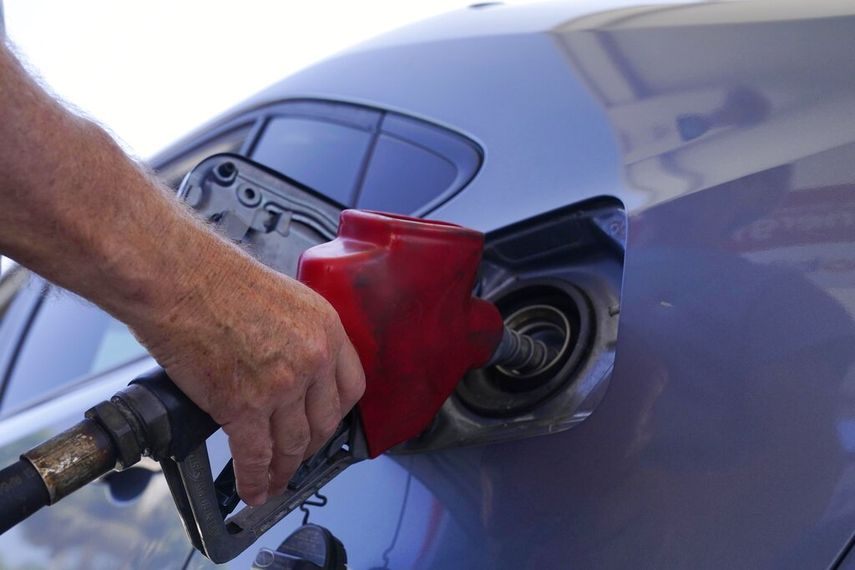 Un conductor rellena de combustible su auto.