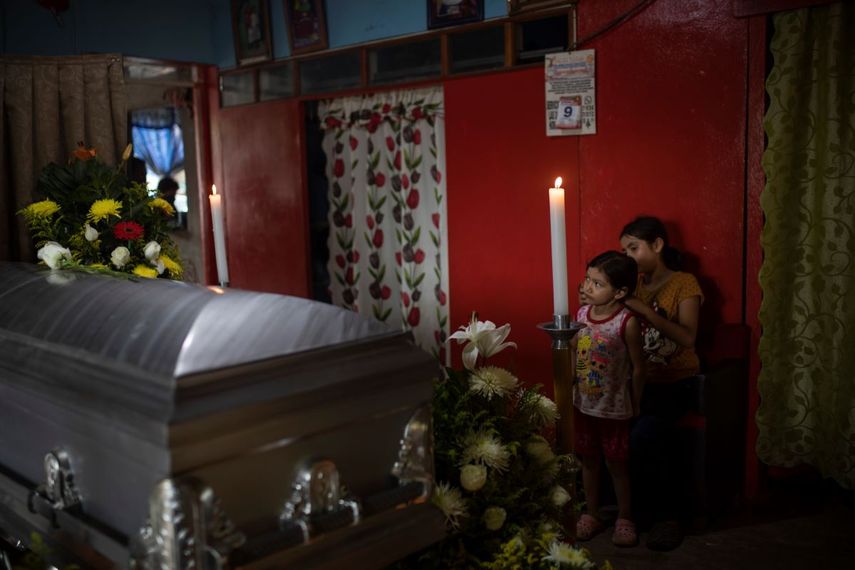 Dos de las seis hijas del periodista asesinado Julio Valdivia de pie junto a su ata&uacute;d durante un velorio en su casa ubicada en Tezonapa, Veracruz, en M&eacute;xico, el jueves 10 de septiembre de 2020.&nbsp;
