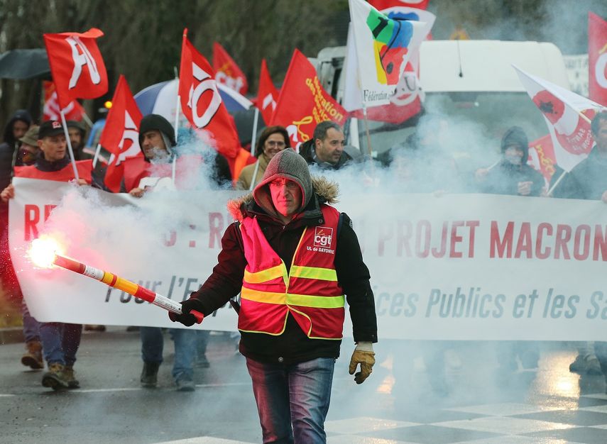 Un manifestante sindical sostiene una baliza durante una manifestaci&oacute;n en Bayonne, suroeste de Francia, el jueves 12 de diciembre del 2019.&nbsp;