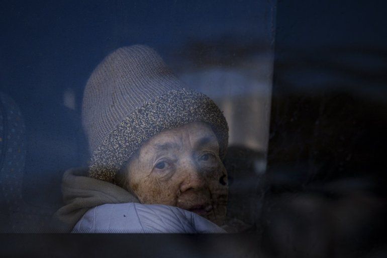 Un refugiado que huye de la guerra de la vecina Ucrania mira por la ventana de un autobús tras cruzar la frontera entre Rumania y Ucrania, el lunes 14 de marzo de 2022, en Siret, Rumania. 