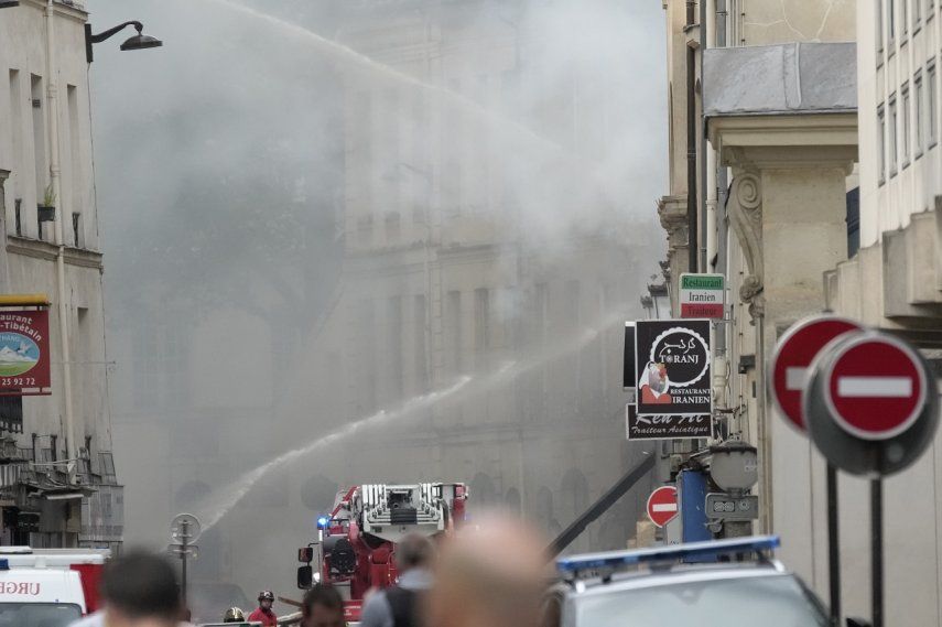 Bomberos combaten con un camión hidrante un incendio en la margen izquierda del Sena, París, miércoles 21 de junio de 2023. Vecinos dijeron a la prensa local que una fuerte explosión precedió el incendio y parte de un edificio se derrumbó.&nbsp;