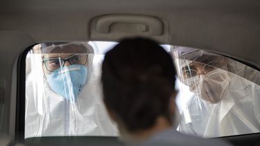 En esta imagen, tomada el 30 de marzo de 2020, personal m&eacute;dico entrevistan a una persona en el interior de un auto para comprobar si padecen s&iacute;ntomas de coronavirus, en Guarulhos, a las afueras de Sao Paulo, Brasil.