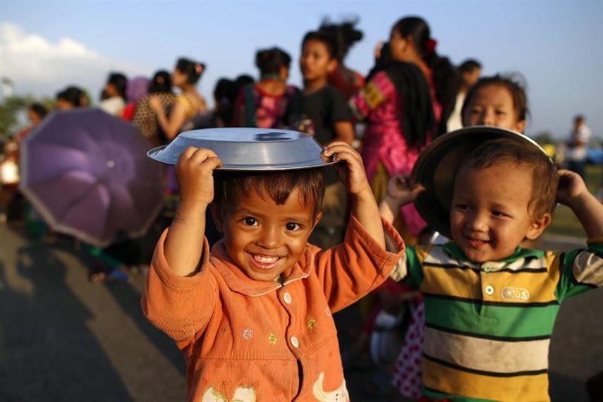  Supervivientes hacen cola para recoger alimentos un día después del nuevo terremoto, en Katmandú (Nepal), el miércoles 13 de mayo de 2015. El número de muertos por el terremoto de 7,3 grados que el martes azotó Nepal se elevó a 76 este miércoles y el