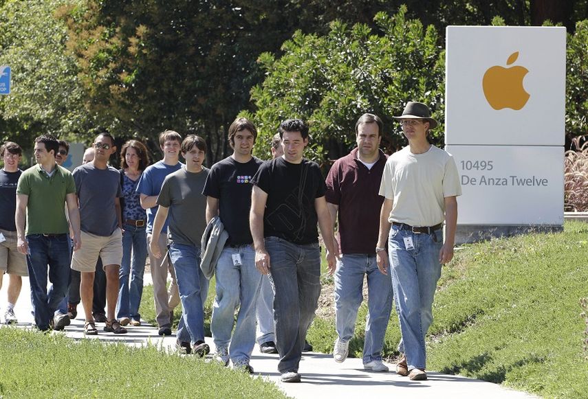 Varios empleados de Apple caminan entre los edificios de la sede de la compañía en Cupertino, California. (AP)