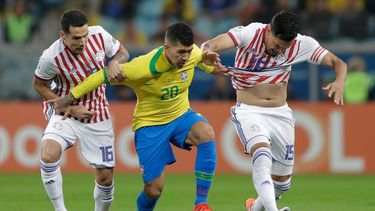 El delantero brasileño Roberto Firmino (centro) se abre paso entre los paraguayos Gustavo Gómez (derecha) y Celso Ortiz en el partido por los cuartos de final de la Copa América en Porto Alegre, Brasil, el jueves 27 de junio de 2019