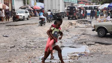 Niñas caminan en calle de Haití.&nbsp;