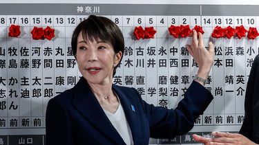 La Primera ministro de Japón y presidenta del Partido Liberal Democrático (PLD), Sanae Takaichi, coloca una rosa de papel roja sobre el nombre de un candidato electo en la sede del PLD durante las elecciones de la Cámara de Representantes en Tokio el 8 de febrero de 2026.