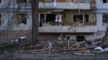 En esta imagen de archivo, un hombre limpia el balcón de un apartamento en un edificio residencial que sufrió graves daños tras un ataque ruso, en Zaporiyia, el 16 de octubre de 2022.&nbsp;