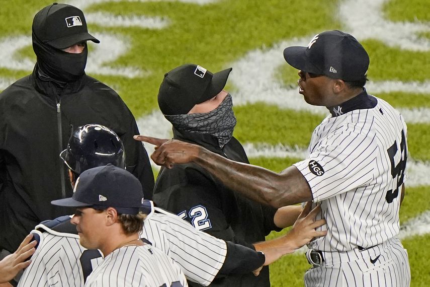 En foto del martes 1 de septiembre del 2020, el umpire de la antesala Jansen Visconti trata de detener al cubano Aroldis Chapman, cerrador de los Yanquis de Nueva York, durante un conato de riña que siguió al último out del juego ante los Rays de Tampa Bay&nbsp;