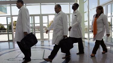 En esta fotografía de archivo del 26 de agosto de 2013, médicos cubanos llegan para recibir capacitación antes de ser asignados a trabajar en áreas empobrecidas donde los médicos y los servicios médicos son escasos, en la Universidad de Brasilia en Brasilia, Brasil.