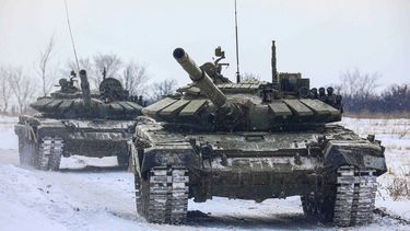 En esta imagen proporcionada por el Servicio de Prensa del Ministerio ruso de Defensa el lunes 14 de febrero de 2022, tanques rusos pasan por un campo durante maniobras militares en la región de Leningrado, Rusia.