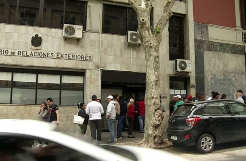 Varias personas esperan a la entrada de la oficina de Migración en la capital uruguaya.