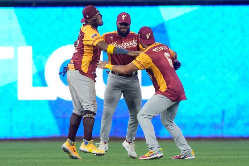 Ronald Acuña Jr. (42), David Peralta (6) y Luis Rengifo (1) celebran la victoria de Venezuela por 5-1 ante Israel en el Clásico Mundial de Béisbol, el miércoles 15 de marzo de 2023, en Miami.