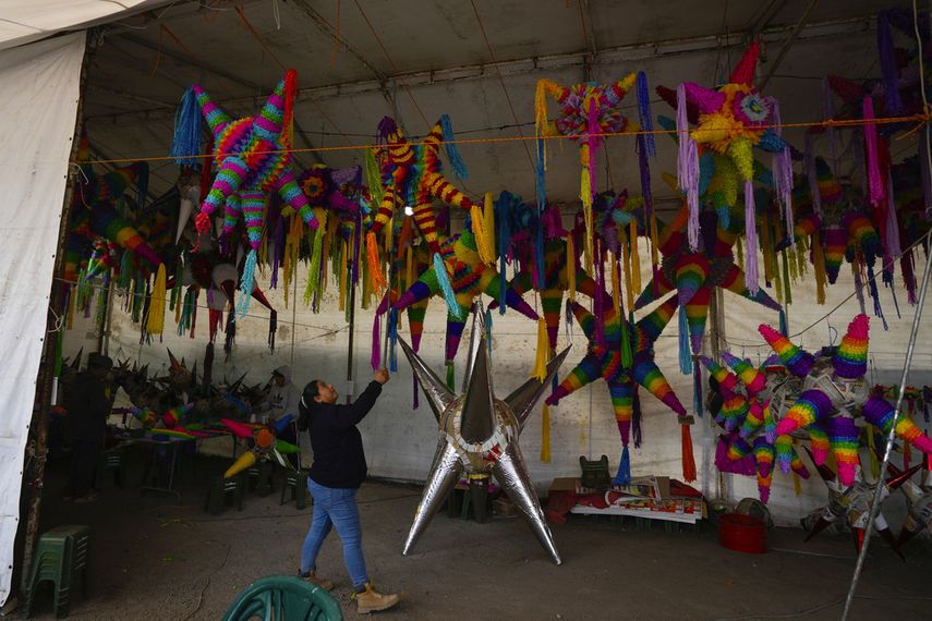 María de Lourdes Ortiz Zacarías vende piñatas en su pequeño negocio familiar en Acolman, al norte de Ciudad de México, el miércoles 13 de diciembre de 2023. La familia empezó con su local en Acolman, donde la madre de Ortiz Zacarías era conocida como 