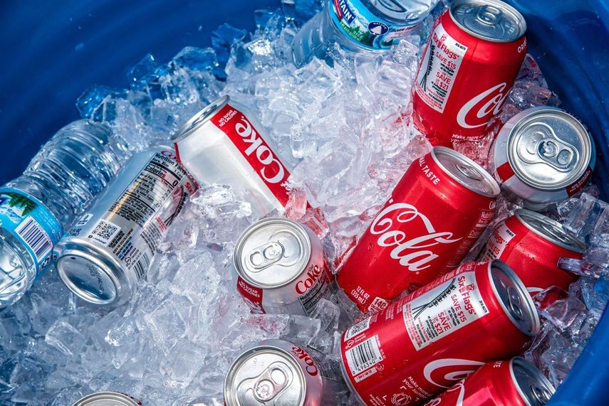Bebidas fabricadas por Coca Cola en un depósito con hielo.