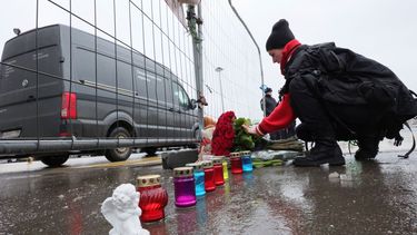 Una mujer deposita flores junto a la cerca del Crocus City Hall, una sala de conciertos de Moscú, Rusia, el 23 de marzo de 2024, un día después de un ataque que dejó varias docenas de muertos. 