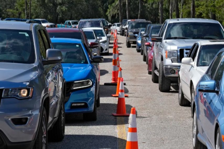 Vehículos forman largas filas para conseguir combustible en una estación recién abierta tras el paso del huracán Milton, el sábado 12 de octubre de 2024, en Plant City, Florida