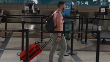 Un viajero solitario se dirije a un mostrador de Frontier Airlines en el aeropuerto internacional de Denver el 22 de julio de 2020, en Denver.&nbsp;
