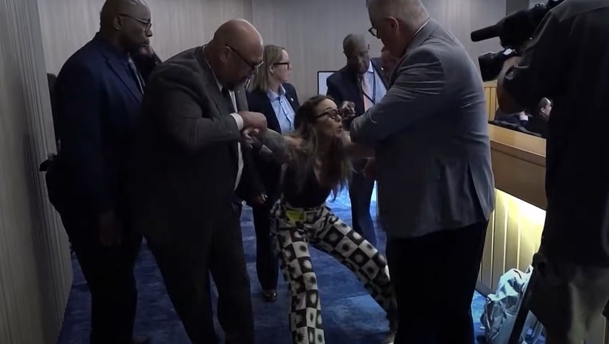 El momento que sacan a una persona del pleno de la Comisión de Miami-Dade que protesta contra ICE