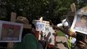 Manifestantes portan cruces con fotografías de víctimas de la masacre en la Escuela Primaria Robb de Uvalde, Texas, durante una protesta el viernes 27 de mayo de 2022 frente al Centro de Convenciones George R. Brown, donde la Asociación Nacional del Rifle efectúa su reunión anual en Houston. 