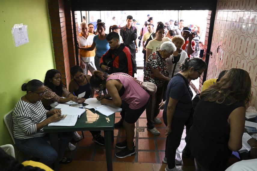 La gente vota en un colegio electoral en el barrio de Petare en Caracas durante las elecciones primarias de la oposición venezolana el 22 de octubre de 2023. &nbsp;