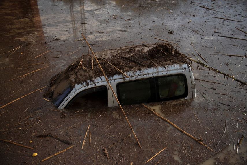 Un coche cubierto de lodo y barro en una calle inundada de Álora, cerca de Málaga, el 29 de octubre de 2024, después de que una fuerte lluvia azotara el sur de España. 