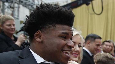 Jerry Harris conversa con una actriz en la alfombra roja de los premios Oscar, afuera del Teatro Dolby en Los Ángeles, el 9 de febrero de 2020. Un juez federal sentenció el miércoles a Harris, exprotagonista de la serie documental de Netflix “Cheer”, a 12 años de prisión por obligar a adolescentes a enviarle fotos y videos obscenos de ellos mismos y solicitar sexo a menores en competencias de porristas.