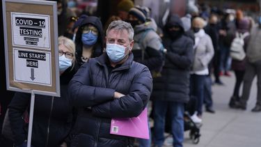 Gente espera en la fila para hacerse una prueba de COVID-19 en Times Square, Nueva York, el lunes 13 de diciembre de 2021. Teatros en Londres y NY lidian con nuevos brotes.