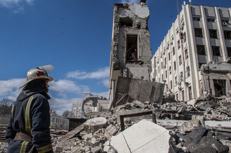 Rescatistas trabajan entre los escombros de un edificio oficial dañado por las bombas, en Járkiv, Ucrania, el 18 de marzo de 2022. 
