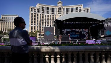 Gente observa a los trabajadores que montan el escenario para el Draft de la NFL que comienza el jueves en las Vegas el martes 26 de abril del 2022.