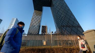 Fotografía de archivo del 4 de febrero de 2021 de personas caminando frente a las oficinas generales de la televisora estatal china CCTV y de su brazo para el extranjero CGTN, en Beijing.&nbsp;