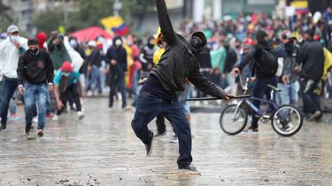 Un manifestante lanza una piedra a la policía en Bogotá.