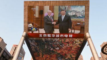 Una transmisión de noticias de la Televisión Central de China muestra imágenes de la reunión del cofundador de Microsoft, Bill Gates (L), con el presidente chino Xi Jinping, en una pantalla gigante afuera de un centro comercial en Pekín el 16 de junio de 2023.&nbsp;