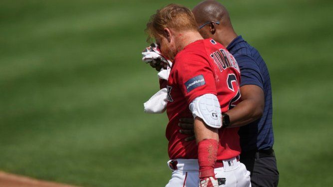 El pelotero de los Medias Rojas de Boston, Justin Turner, abandona el campo tras recibir un pelotazo en la cara en un lanzamiento del pitcher de los Tigres de Detroit, Matt Manning, durante un encuentro de pretemporada, el lunes 6 de marzo del 2023.