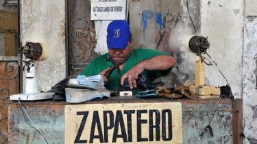 Un hombre se busca la vida reparando zapados en La Habana, Cuba.