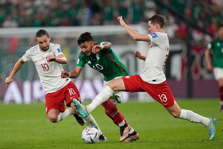 Alexis Vega, de México, pelea por la pelota con los jugadores polacos Jakub Kaminski (13) y Grzegorz Krychowiak (10) durante el encuentro entre ambas selecciones en el Stadium 974 de Doha, el martes 22 de noviembre de 2022.