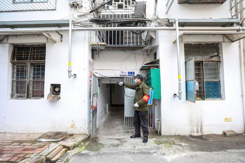Un empleado del gobierno rocía desinfectante en un edificio residencial en Wuhan, en la provincia de Hubei, China, el martes 28 de enero de 2020. 
