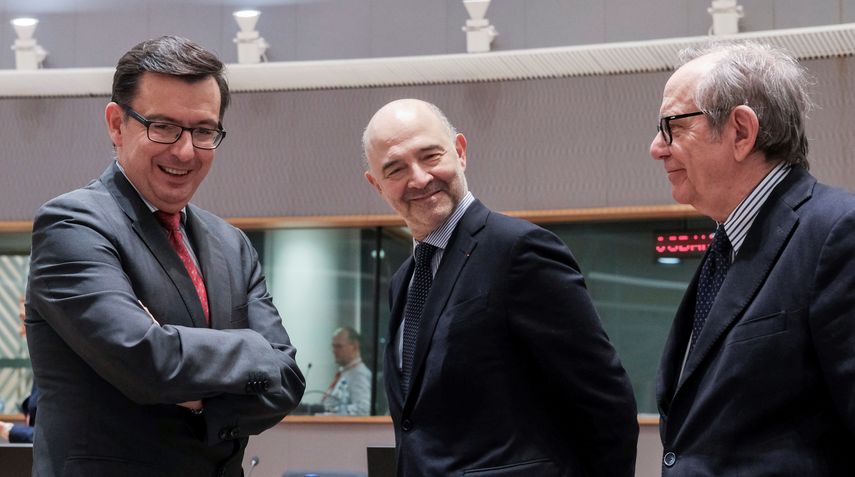 El ministro de Economía, Industria y Competitividad, Román Escolano (izda), conversa con el comisario de Asuntos Económicos, Pierre Moscovici (c), y con su homólogo italiano Pier Carlo Padoan, durante la reunión del Eurogrupo.