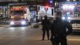 Dos policías vigilan durante el operativo para remover el camión con el que se perpetró el atentado de este vienes en Estocolmo, que causó la muerte de al menos cuatro personas.