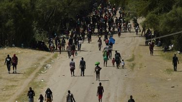 Migrantes haitianos caminan por un camino de tierra después de ingresar a Estados Unidos desde México, el viernes 17 de septiembre de 2021, en Del Rio, Texas.&nbsp;