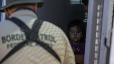 Una joven migrante desde el interior de una camioneta mientras un agente de la Patrulla Fronteriza recopila información de sus padres, en la frontera entre Estados Unidos y México el 12 de mayo de 2021 en Yuma, Arizona.&nbsp; &nbsp;