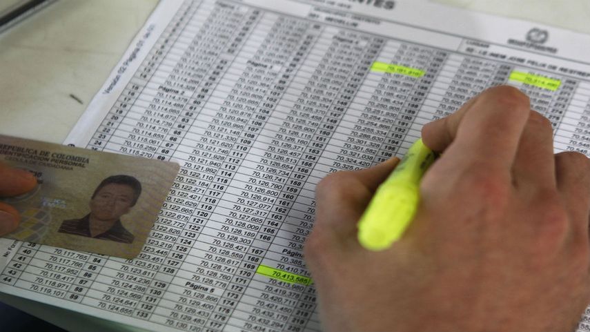Un miembro de mesa registra a un elector en un centro de votación en Medellín, Colombia