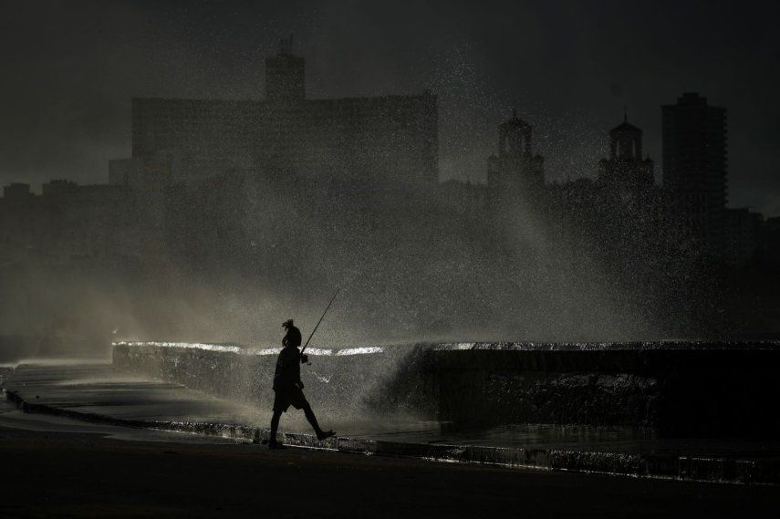 Una persona pesca a lo largo del malecón mientras las olas rompen durante un corte de energía en La Habana, Cuba, el lunes 21 de octubre de 2024.&nbsp;